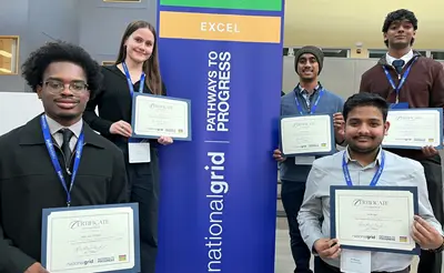 Five students hold up certificates at a National Grid event.