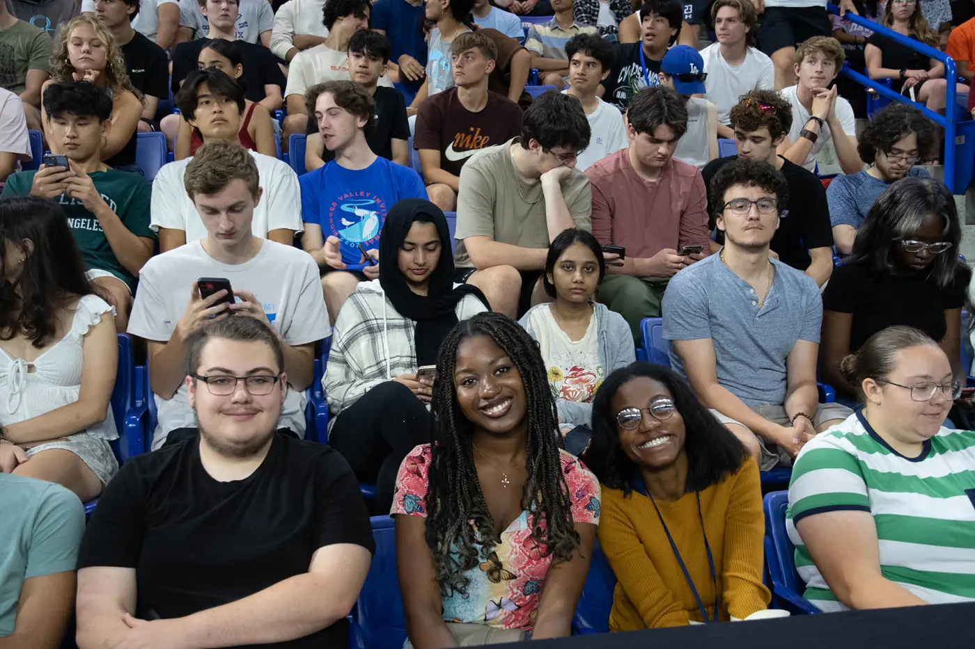 Students sitting in seats at Convocation smiling