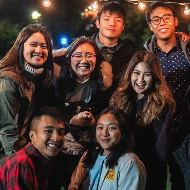 Seven student pose at the night market.