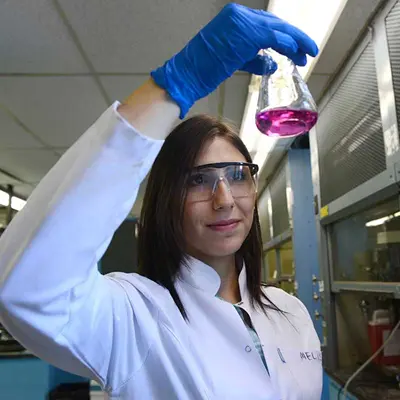 Student holding a beaker in a lab