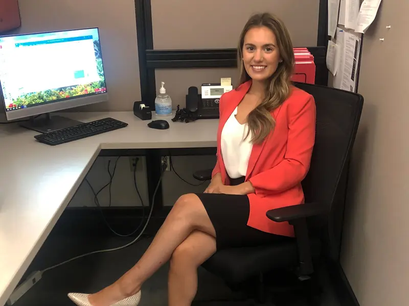 Ashley Ventrillo in her cubicle at work