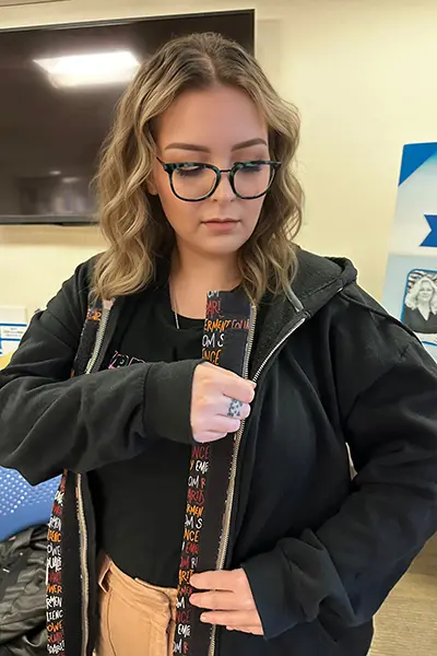 Sandi DeRuntz demonstrates a prototype of ZipperBuddy, the adaptive device she invented