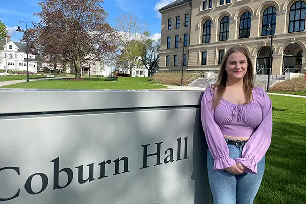 Liberal Arts Gabrielle Salvatore '24 in front of UMass Lowell's Coburn Hall