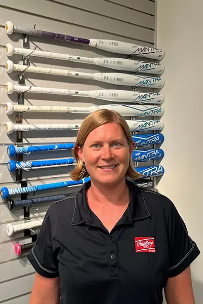 Becky O'Hara, head of research and development at Rawlings, poses in front of a wall of bats