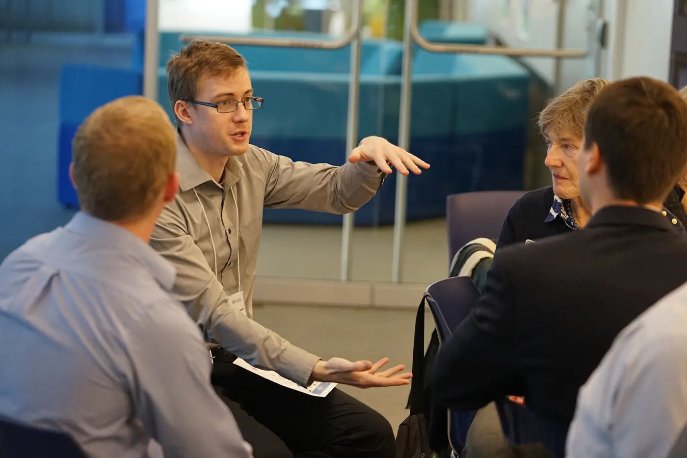 Four faculty members discuss around table