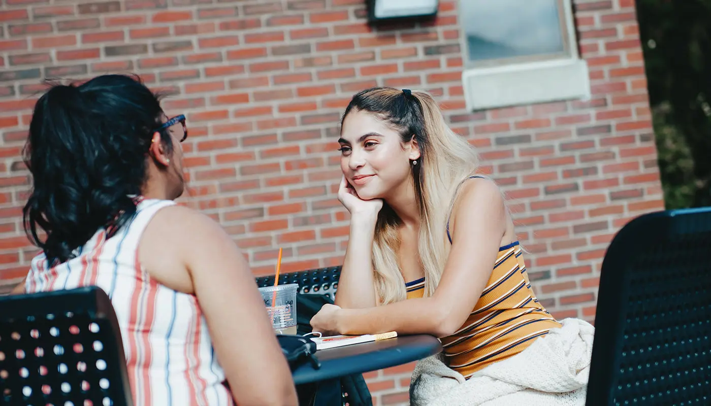 Two women at table outside