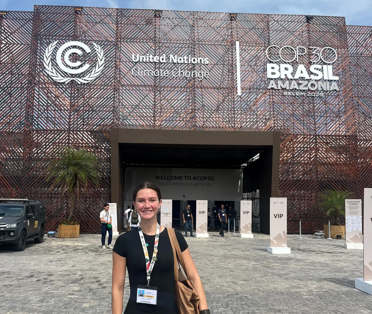 Cate Kleeman stands under a COP 30 sign.