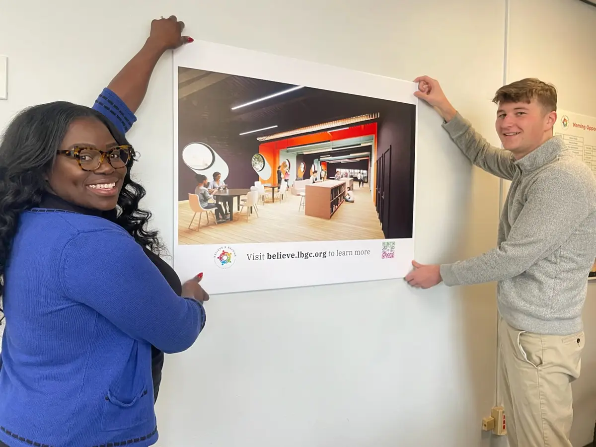 Andrew Lucier and Justien Martin hold up a banner