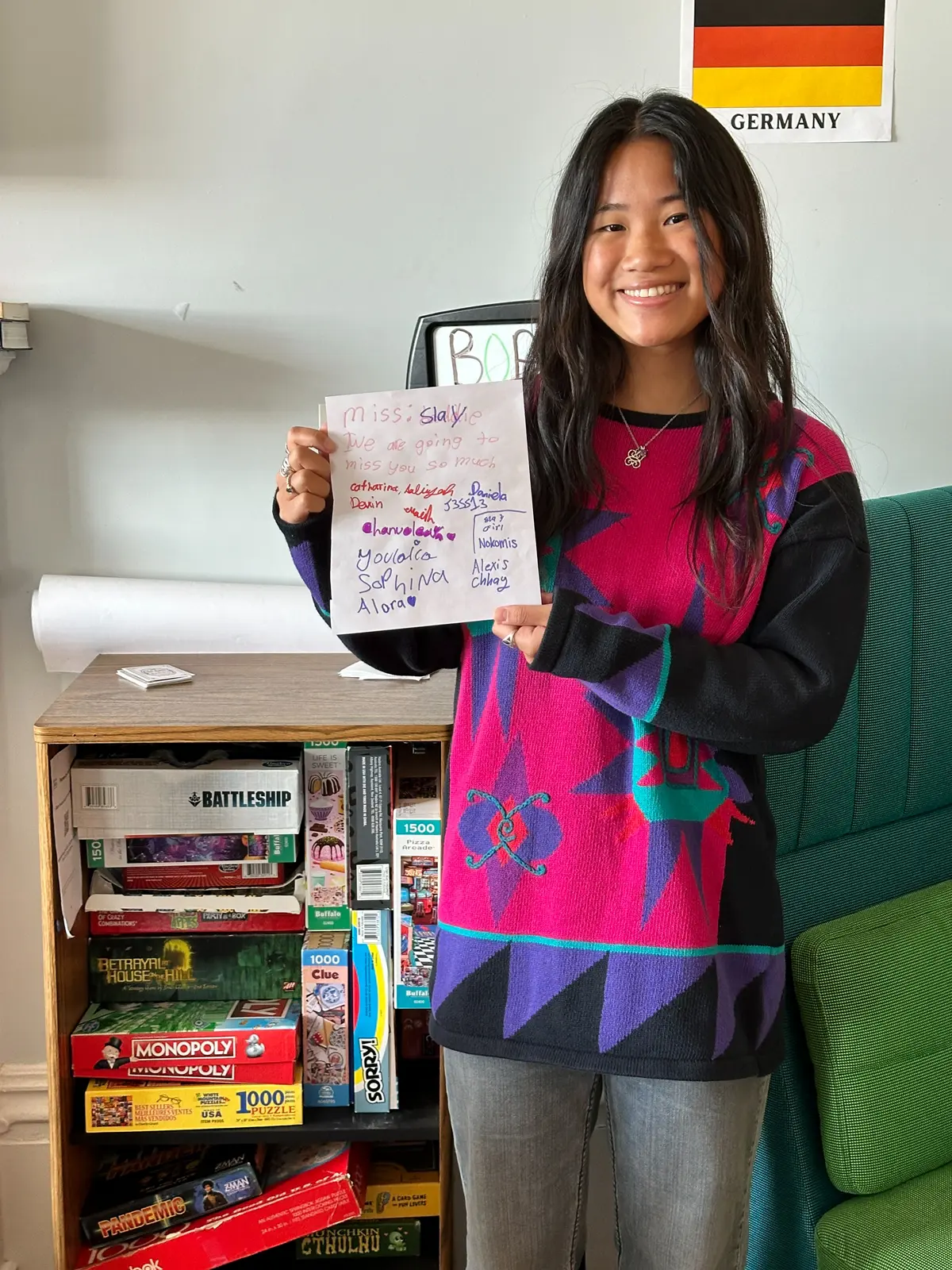 Nokomis Bramantecohen holds up a thank you card that 4th grade girls made for her