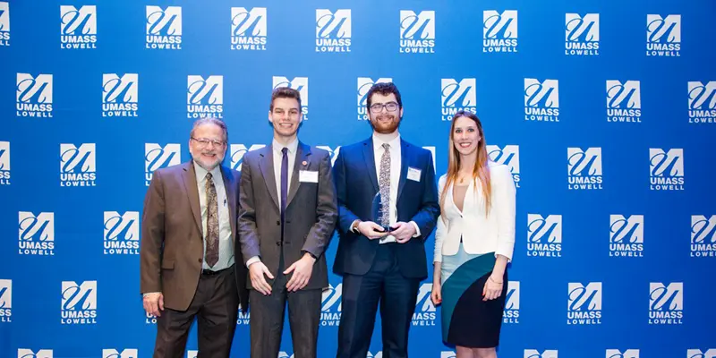 Nicholas Norcross and Kevin Seery onstage with Steve Tello, Holly Butler and their “Significant Social Impact” award at the 2018 DifferenceMaker Idea Challenge, a $4,500 prize they are using to develop their ClassRoots application platform