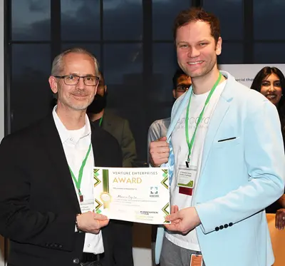 Joe Vaillancourt presents an award certificate to Jan-Georg Rosenboom.