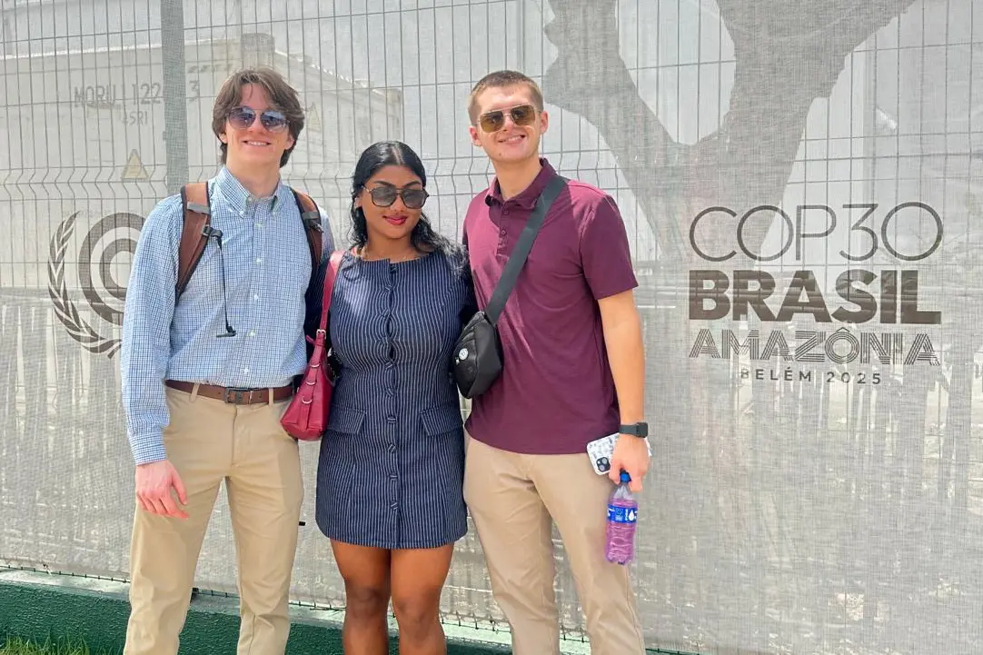 Colin Ormond, Angel Molekunnel and Andrew Fenner stand next to a COP 30 sign.