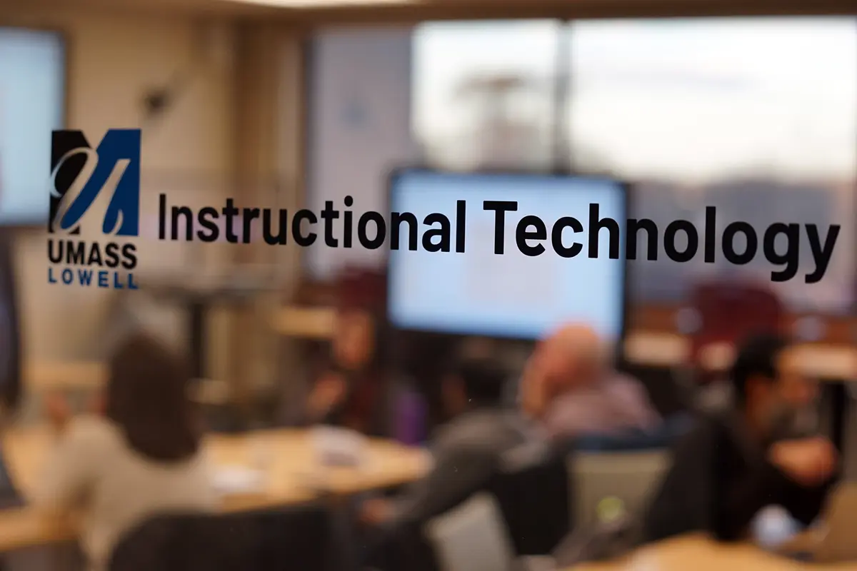 The words Instructional Technology are on the window of a classroom.