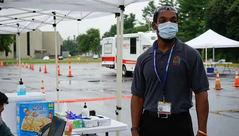 Dan Howell conducting COVID testing in parking lot tent