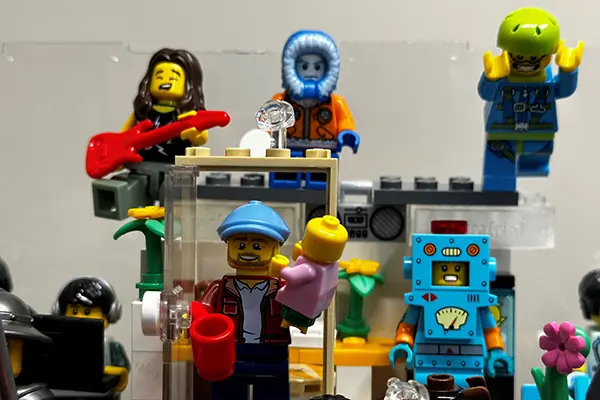 Lego figures representing David Claudio in Montana, skydiving and holding his daughter