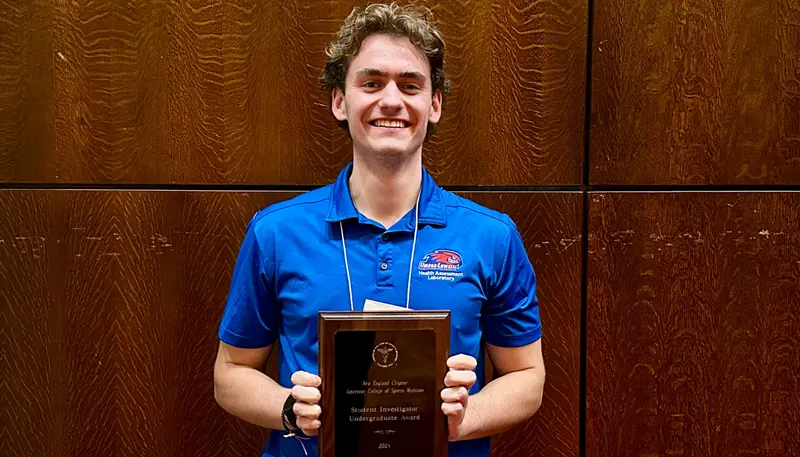 Donald Rogers holding award.