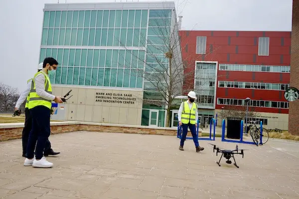 The team prepares to launch the drone in front of Saab ETIC