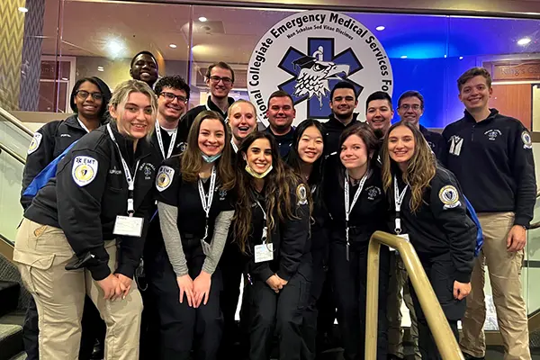 A group of 16 student EMTs pose for a group photo