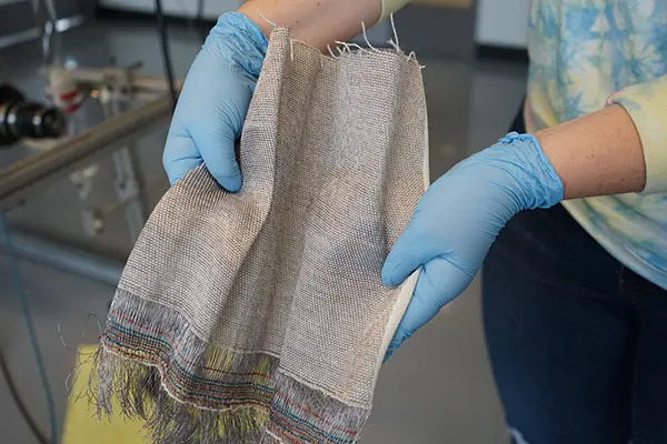Closeup of gloved hands holding fabric