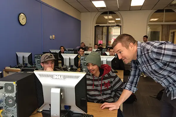 Asst. Prof. David Kingsley checks on an experimental economics game at UMass Lowell