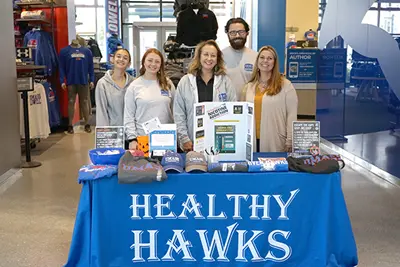 students and staff pose for a photo at the vape pen exchange table