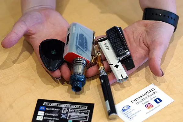A student holds some of the collected vape pens