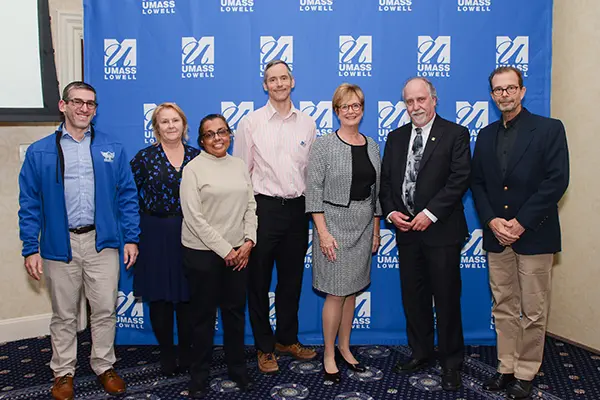 Chancellor Jacquie Moloney poses with award winners