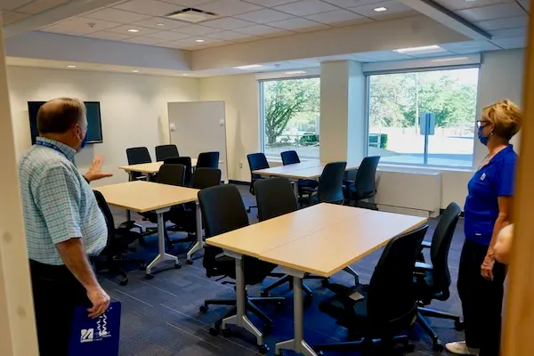 Steve Tello and Jacquie Moloney look at a classroom