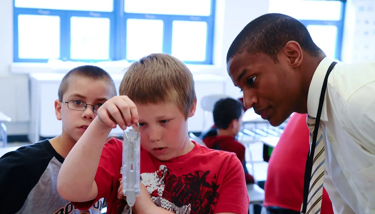 Education intern with two young boys
