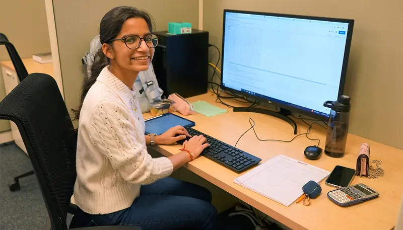 Garima working at a desk