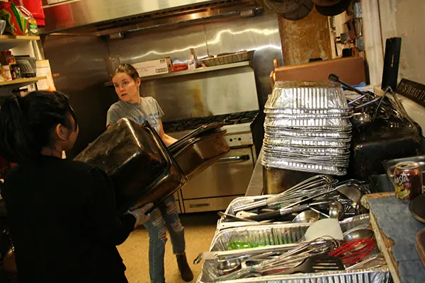 Grad students organize the kitchen at the LTLC