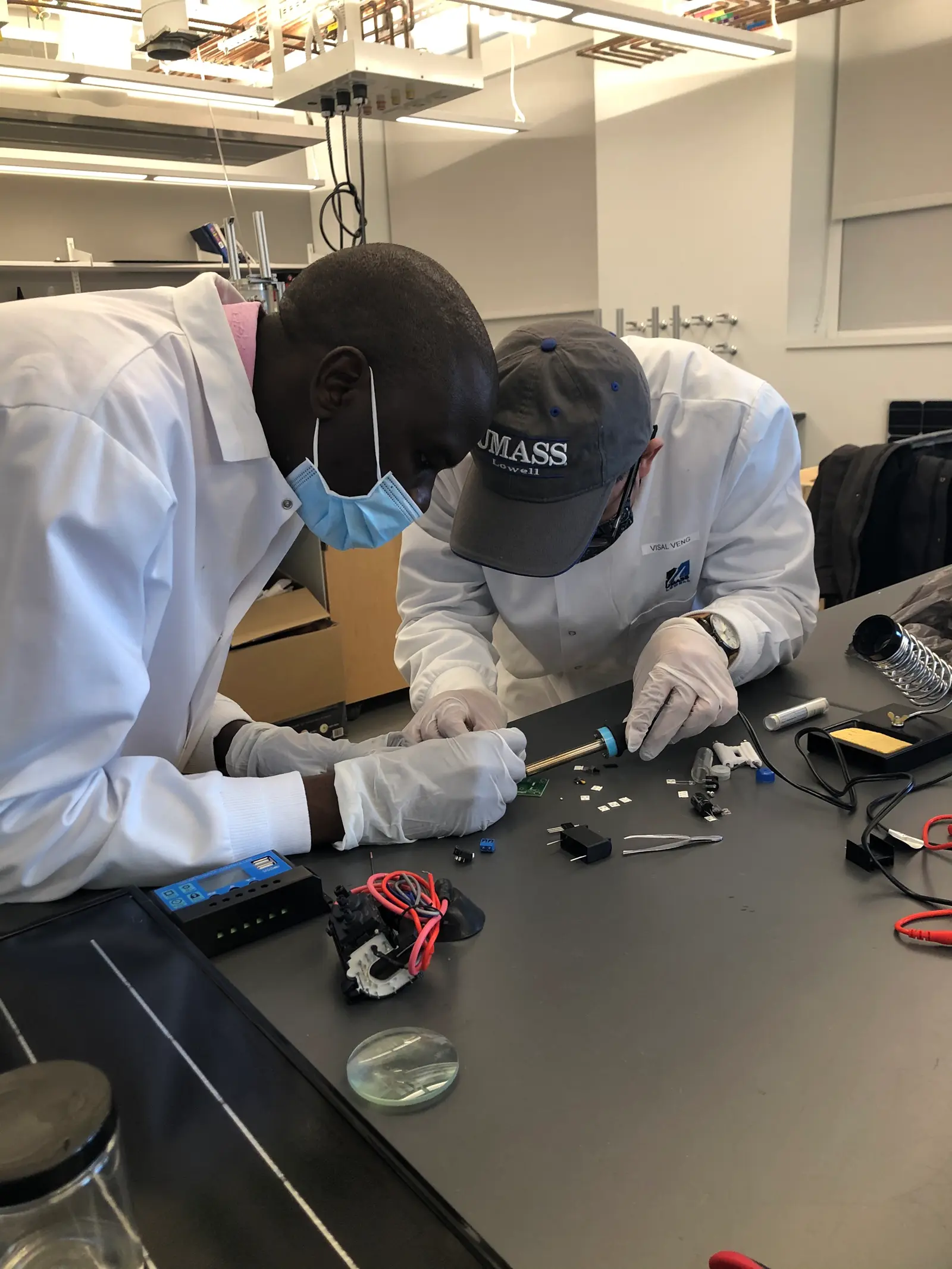 Team members working on their project's prototype in a lab setting.
