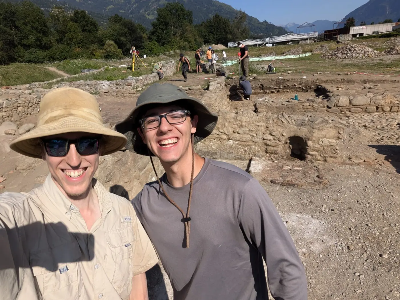 UMass Lowell history major Collin Powers and a friend pose in a Roman room they excavated.