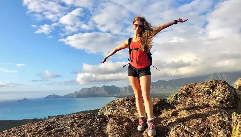 Isabella De Souza on a hill overlooking a lake