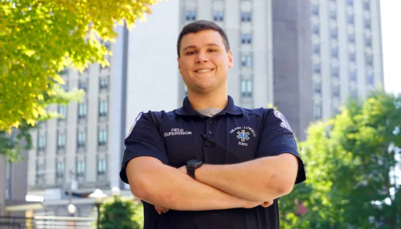 Joe Mendes poses wearing his UMass Lowell EMS uniform
