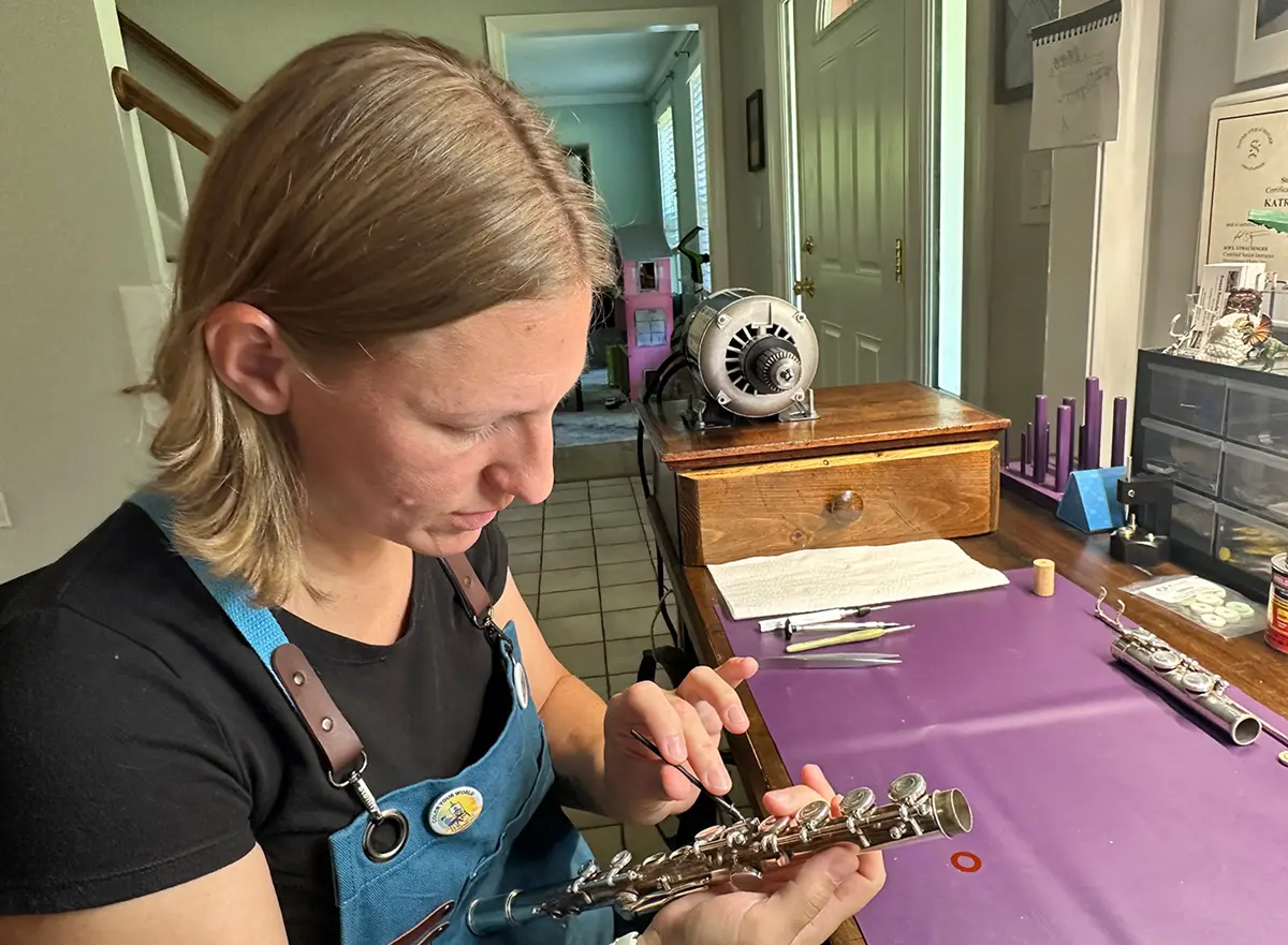 Katrina Cruess working on a flute.