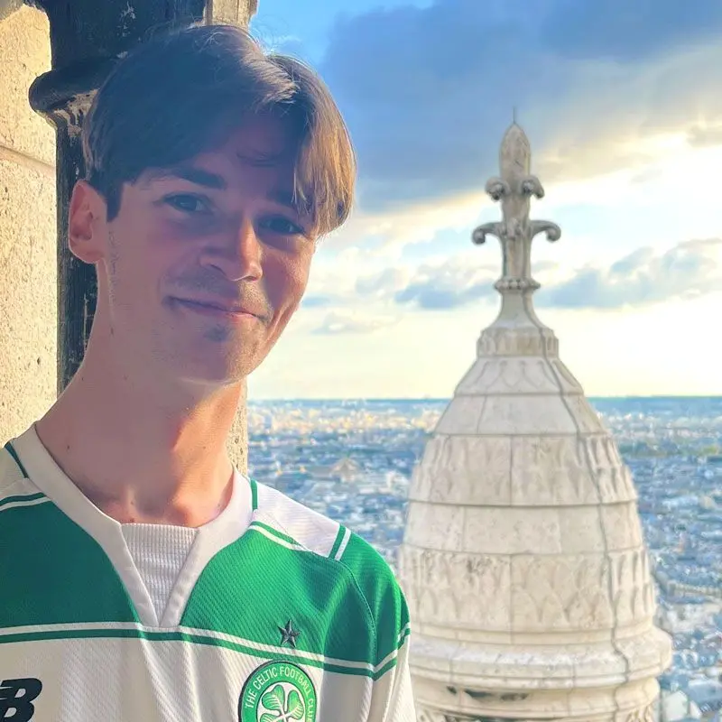 Kevin Harrington poses with the city of Paris in the background.