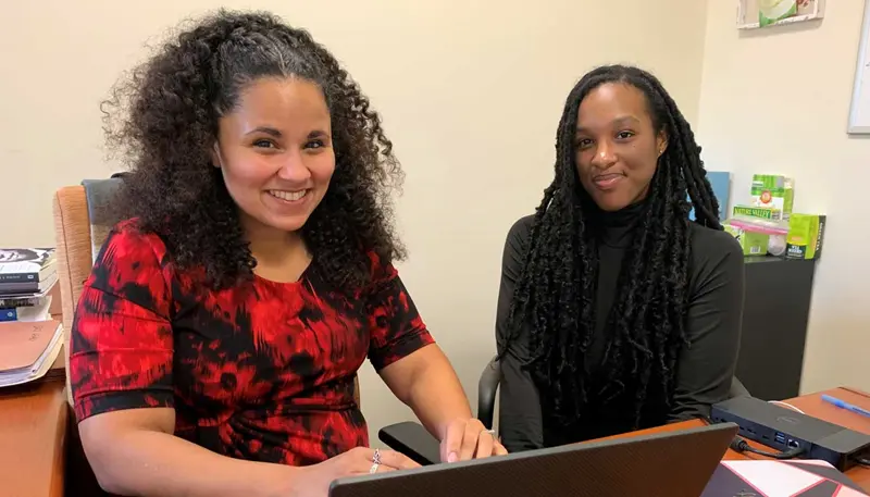 Kimani sitting next to professor Chandra Waring