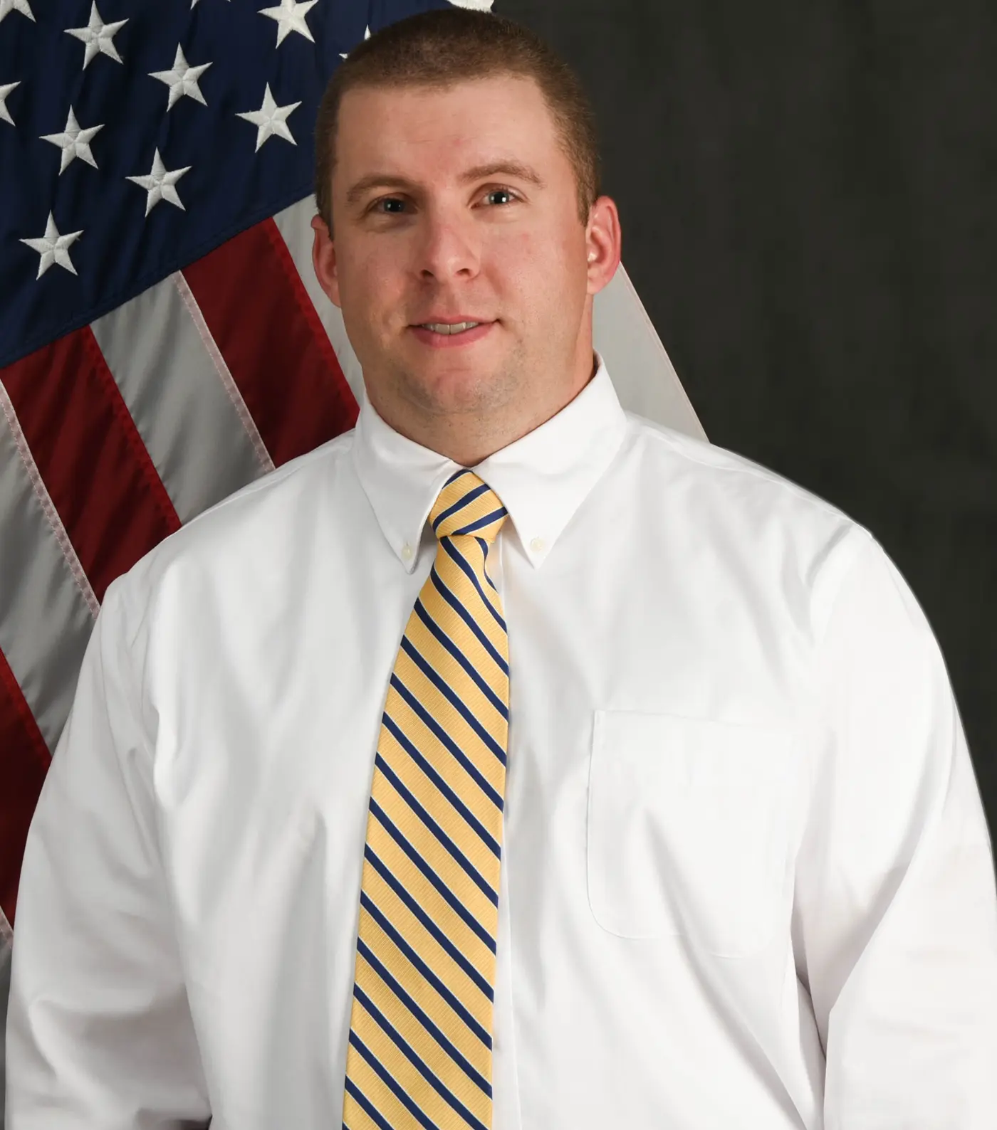 Tim Lawton infront of a US Flag.