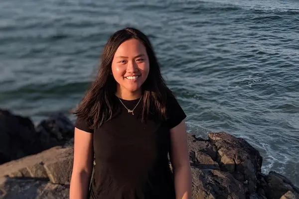 Linh Nguyen posing in front of water