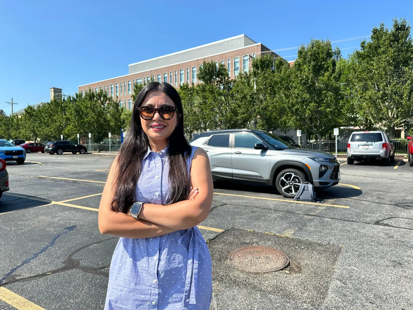 Mahsa Ghandi stands near a test geothermal borehole in a South Campus parking lot