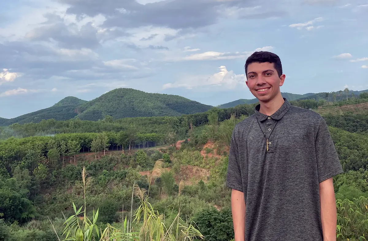 Mars Orfanos with a mountainside behind him.