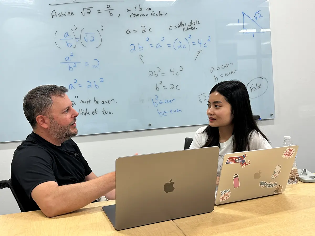 Visiting Lecturer Matthew Beyranevand, left, explains a story to student Kelly Duong