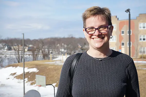 UMass Lowell Sociology Assoc. Prof. Mignon Duffy with the Merrimack River in the background