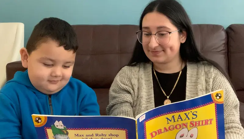 Nery Rodriguez reads with a child