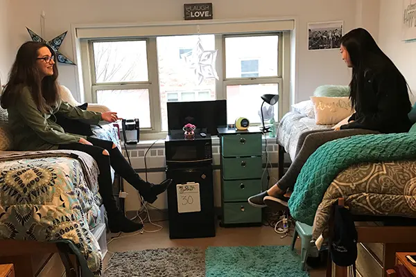 W.I.S.E. members Gina Mician and Alexsia Khim in Mician's room in Leitch Hall.