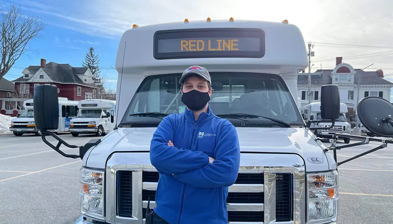 Shuttle driver Nicholas Benjamin in front of his shuttle