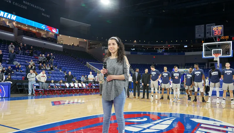 Nicole Hayek sings the national anthem before the UMass Lowell men's basketball game on Martin Luther King Jr. Day at the Tsongas Center