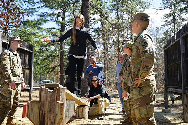 Holly Butler crosses a bridge on the leadership reaction course