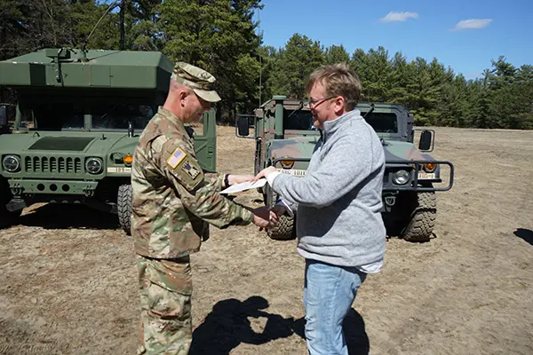 David Greenway receives a certificate from Josh Goodrich